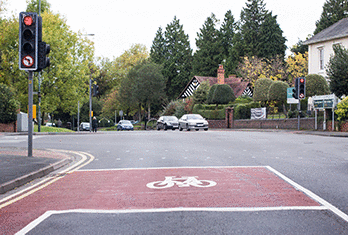 This junction, controlled by traffic lights, has a marked area between two stop lines. What's this for? - This junction, controlled by traffic lights, has a marked area between two stop lines. What's this for?